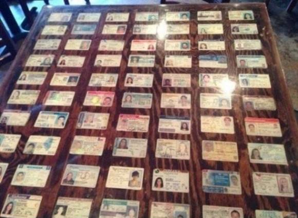 Bar decorates their tables with seized fake IDs.