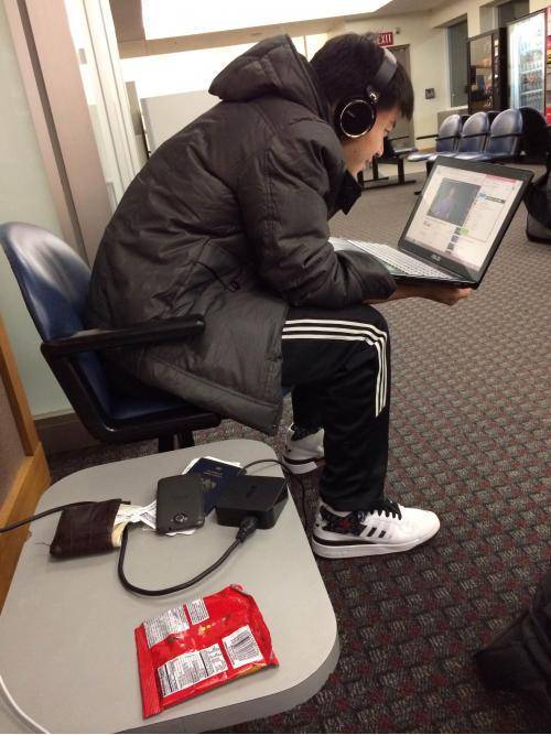 If ever someone was just asking to get robbed, it's this guy sitting next to me at the airport
