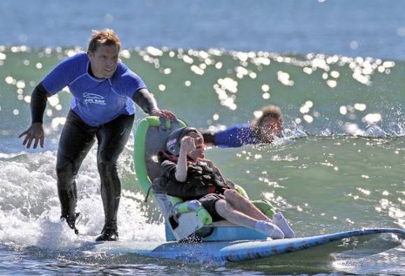 Surfers give a disabled person a thrilling ride on the waves... Inspirational 