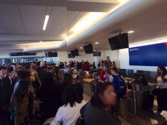 Delta customer service at LAX. One poor employee working while hundreds of people wait to rebook missed flights because of the understaffed nightmare at check-in. Literally everyone you see is in line.
