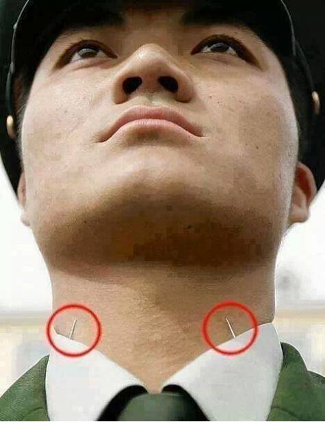 Chinese soldiers place needles in collars to maintain head position during Chinese parades