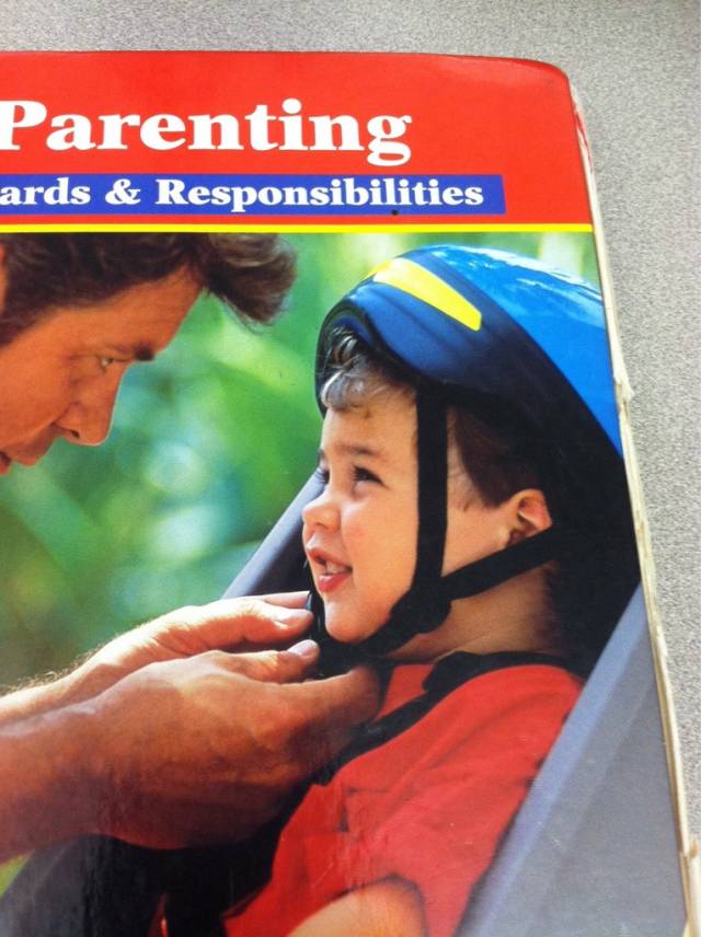 The dad on my Child Development book is putting the kids helmet on backwards.