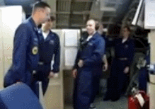 Sailors on a submarine maintain their balance while it does a 29 degree up angle.