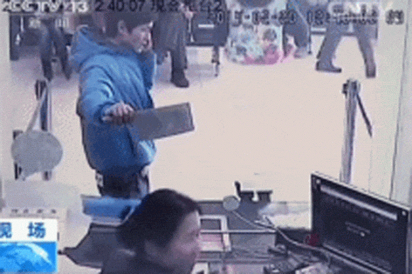 Bank teller laughs at robber.