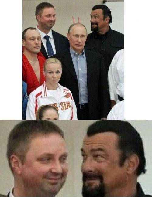 Stephen Segal gives Vladimir Putin bunny ears.