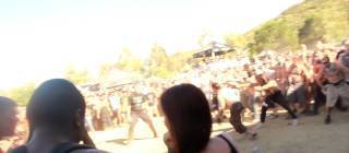 Black guy with a soda finds himself in the middle of a mosh pit.