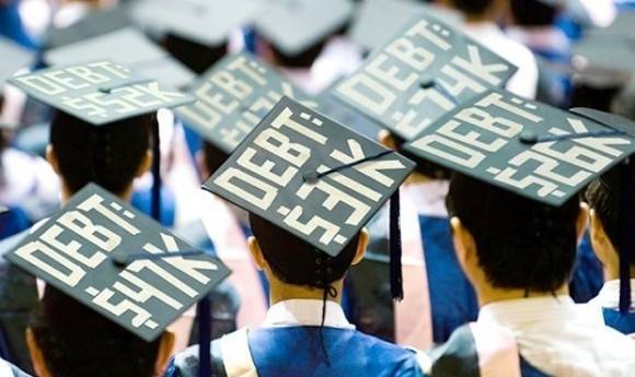 Students wear how much debt they are in on their graduation caps.