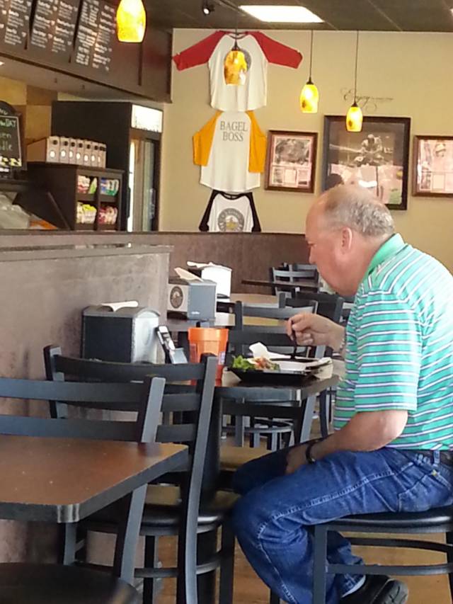 This guy is using an iPhone to prop up a Galaxy to watch Netflix out loud in a restaurant. I can only dream of giving this few f*cks