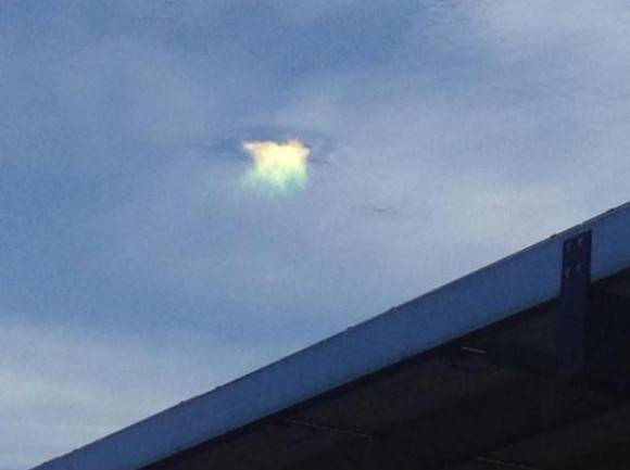 A weird light appeared in the sky. Local news said it’s light refracting from ice crystals falling through the cloud.