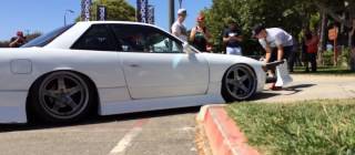 Lowered Nissan rips off bodykit trying to get up driveway.