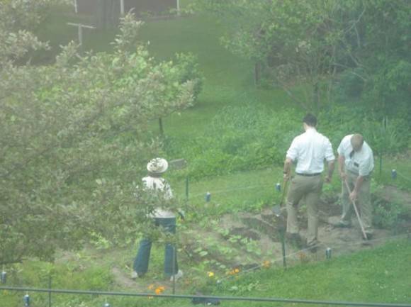 The Mormons insisted on speaking to my mom. So here they are helping her garden.