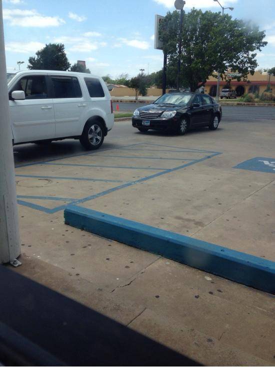 This car has been sitting there for 15 minutes thinking it’s the drive thru. The car in front is parked in a parking spot.
