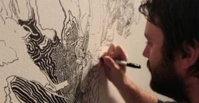 Artist Draw A Nature Inspired Mural Using A Black Marker... 