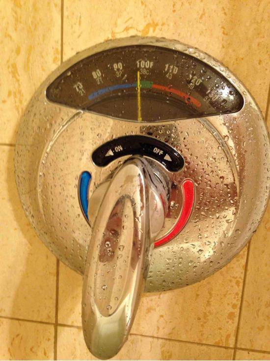 This shower has a thermometer for the water.