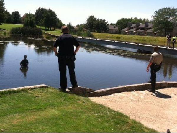 Suspect in my hometown jumped into the middle of a pond to avoid arrest; standoff ensued.