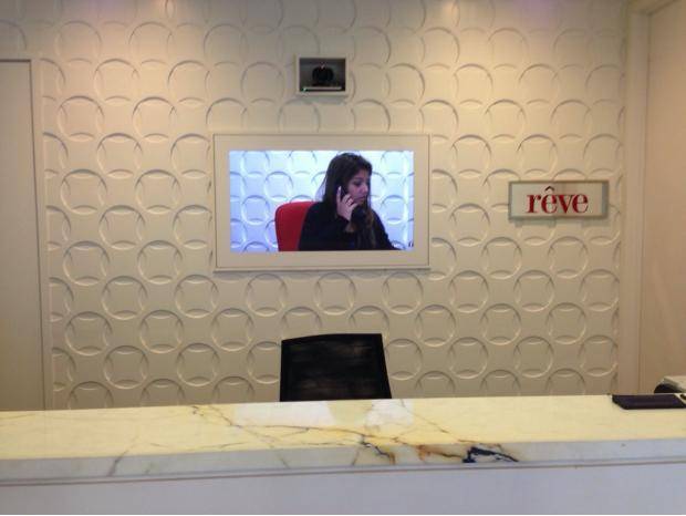 Outsourcing is getting out of hand. This concierge at a condo building is being skyped in.