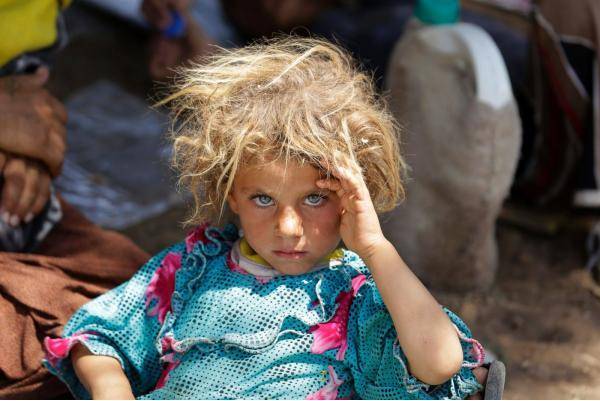 Yazidi girl rests after fleeing from ISIS