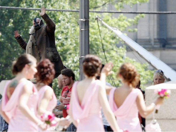 Tom Hardy waves at a bridal party while filming 
