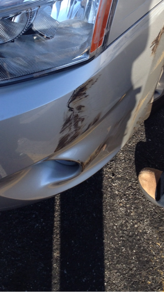 A face was scuffed into my car after a minor car accident...