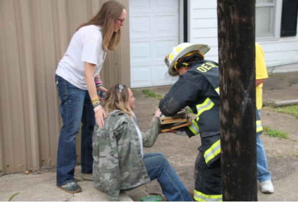 Firefighter in my home town hands woman her family pictures he saved from her burning house.