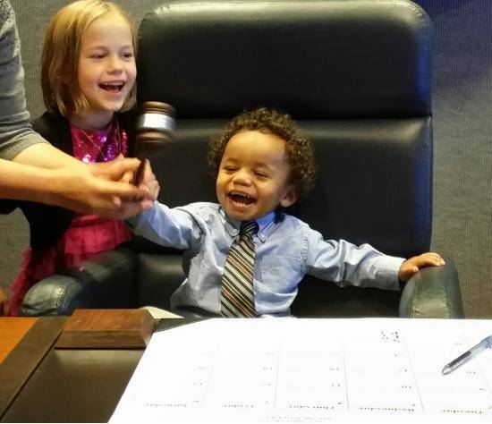 Our son and his big sister ringing in his official adoption and the end of his time in foster care.