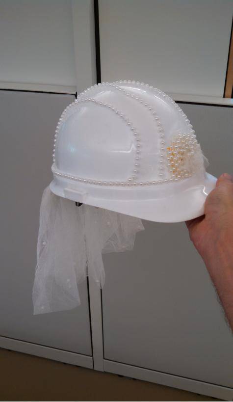 A project manager from our office is getting married, so we decorated a hard hat for her.