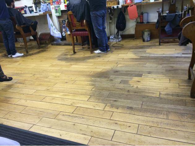 Barbershop floor worn away after decades of barbering