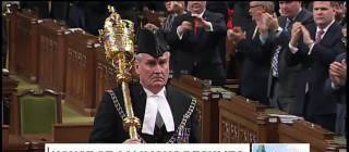 Sergeant-at-Arms Kevin Vickers enters the Commons to a standing ovation