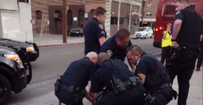 9 Officers Arrest One Teenager. Cop Appears To Hit Teen In Face With Baton For Jaywalking And Resisting Arrest.