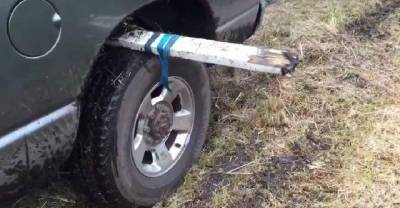Man Straps Wood To His Truck Tire, Then Steps On The Gas Revealing A Neat Trick