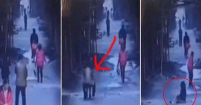 Wtf! Watch What Happens To This Woman While Walking Down The Street In China.