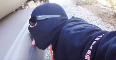 Crazy Guy Licks A Freight Train While Its Moving