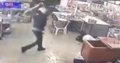 Brutal Moment 'Machete-Wielding Thug Runs Into Restaurant And Hacks At Man'
