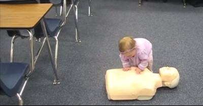 Future Hero Baby Practices Giving CPR To Dummy
