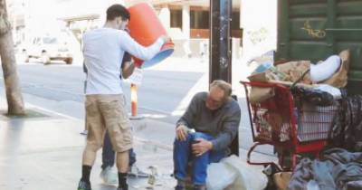 Guys Pour Watercooler Filled With Cash All Over Strangers