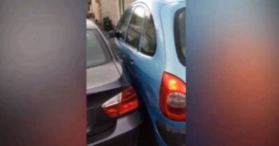 Terrible Parking Attempt Caught On Camera As Motorist Finds Her Car Completely Wedged-In