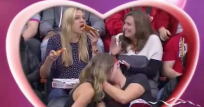 Kiss Cam Catches Girl Eating Two Slices Of Pizza Simultaneously And The Internet Is Loosing Its Mind