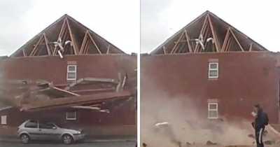 Man Casually Strolls Past House As It Collapses To The Ground