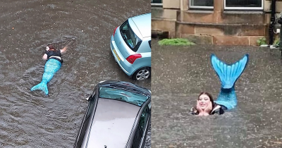 Woman Dressed As A Mermaid Swims In Floodwater