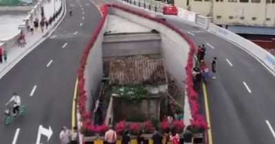 Chinese City Builds Motorway Bridge Around Tiny House After Owner Refused To Move